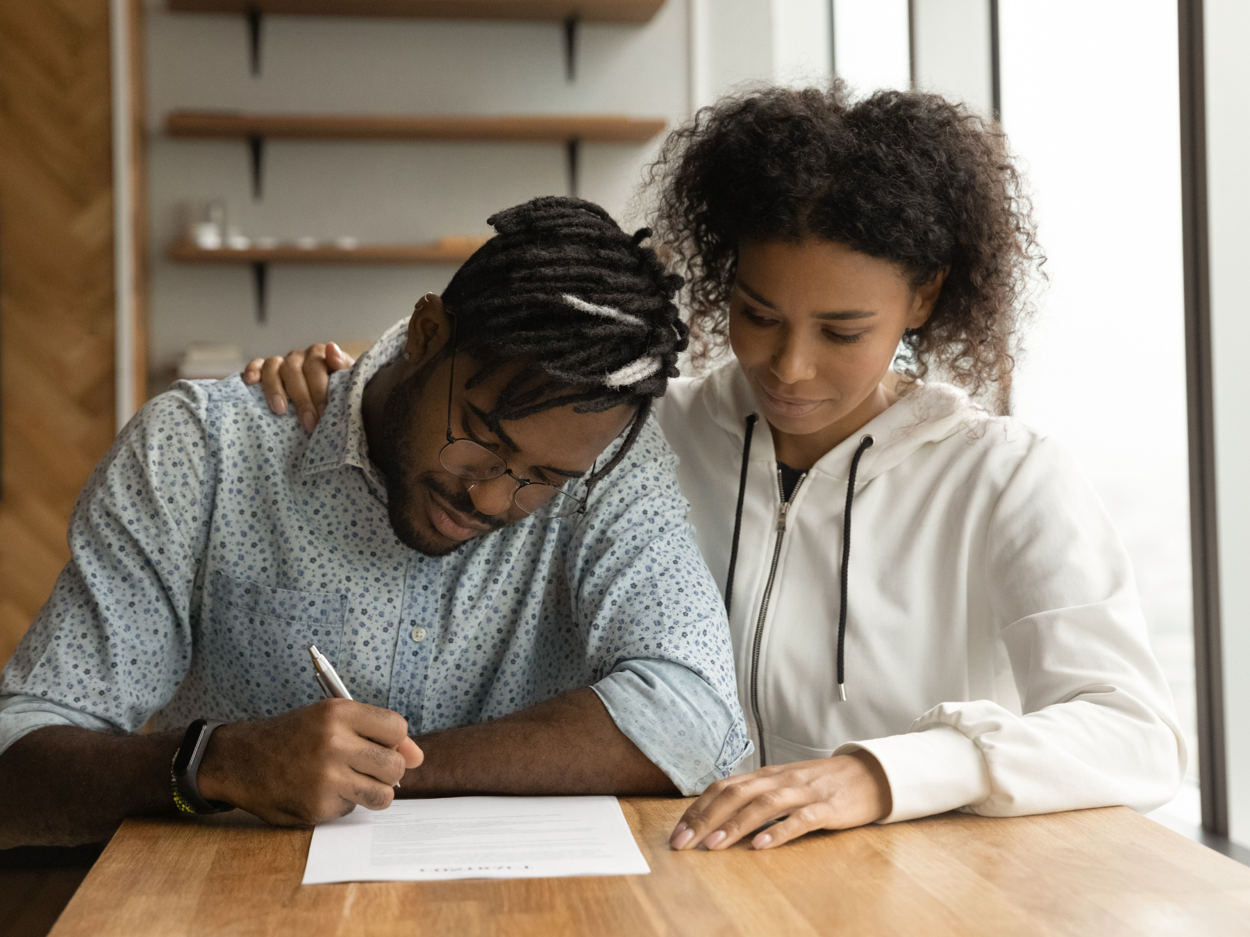 man and woman signing a Will and Probate